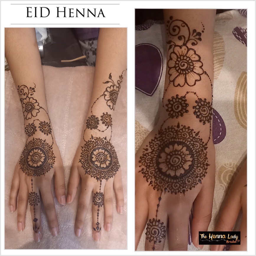 Two hands decorated with henna